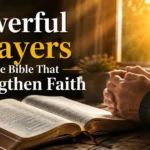 Open Bible with folded hands showing powerful prayers in the Bible and Christian faith.